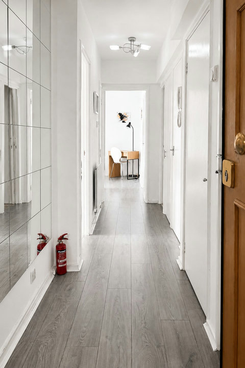 Bright entrance hallway with full-length mirrors and easy access to the bedroom, bathroom, kitchen and living area.