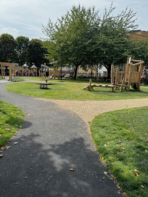 Landscaped children’s play area directly beside the building — a convenient outdoor space for families staying with young children