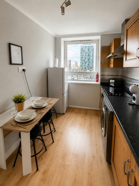 Fully equipped kitchen with dining space, oven, hob, fridge-freezer, coffee machine and washing machine — ideal for short or extended stays.