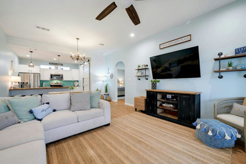 Bright, open living room with a big sectional and smart TV