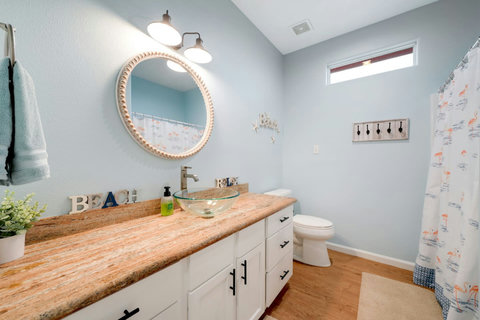 Bathroom with a vessel sink and tub-shower combo