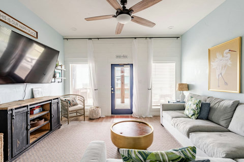 Living room with a door out to the deck