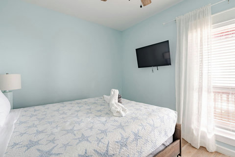 Natural light and a TV in the queen bedroom