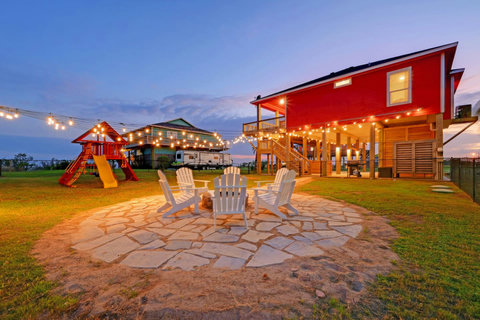 Fire pit under the lights, with a playscape for the kids