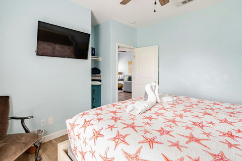King bedroom with a wall-mounted TV