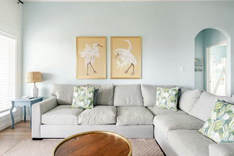 Comfy sectional with coastal art