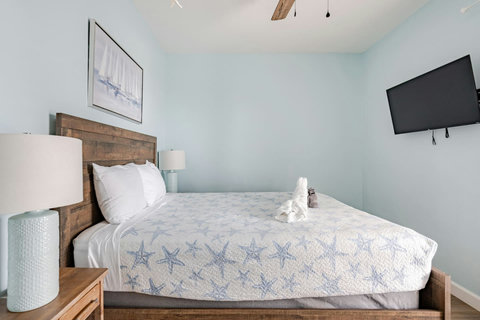 Queen bedroom with a wall TV