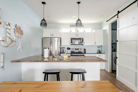 Kitchen with stainless appliances and a sliding barn door