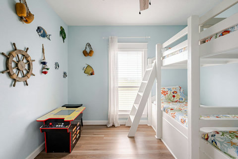 Bunk room with an arcade game