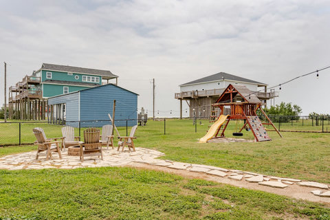 Fire pit and playscape in the fenced yard