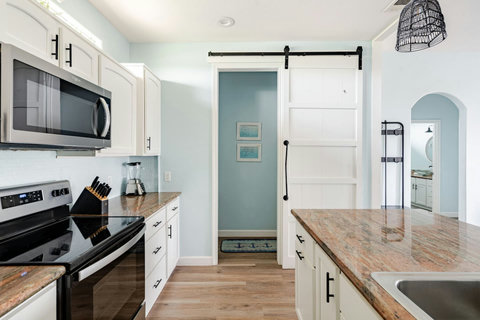 Kitchen with a barn door to the laundry room
