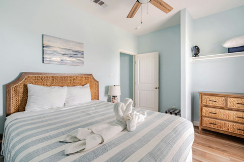 Queen bedroom with a dresser and shelf