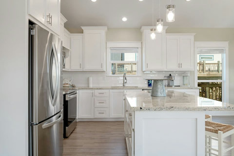 White cabinets and a tile backsplash