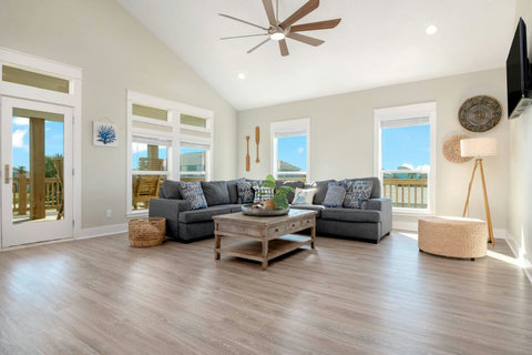 Sectional sofa and smart TV under a vaulted ceiling