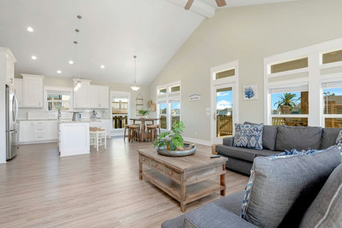 Open living room with vaulted ceilings, flowing into the kitchen