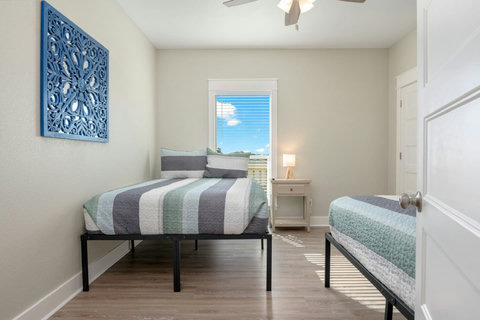 Queen bedroom with coastal art