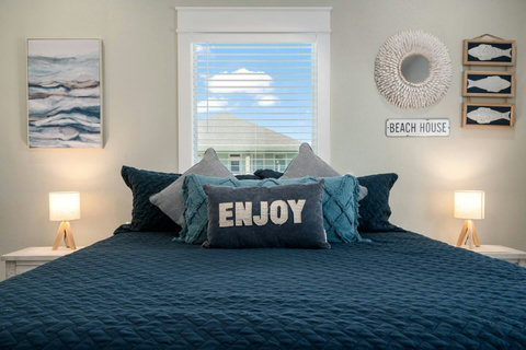King bedroom with soft navy bedding