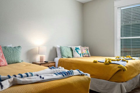 Two queens with sunny yellow bedding