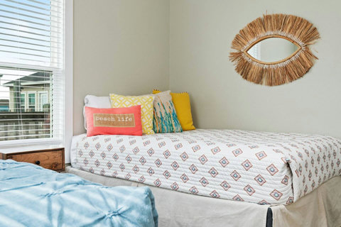 Queen bed with colorful pillows