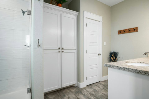 Walk-in shower and linen storage