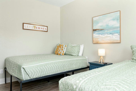 Queen beds with soft green bedding