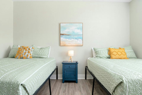 Two queen beds with coastal art