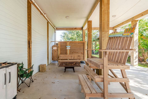 Shaded patio with a picnic table and fire pit