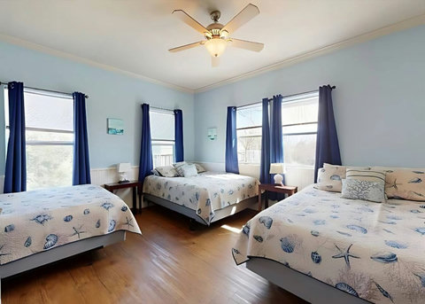 Three queen beds with seashell bedding