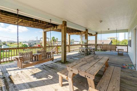 Covered deck with swings and picnic tables