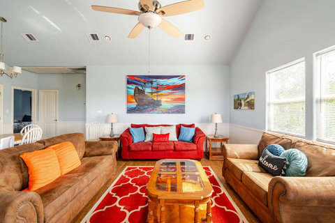 Bright living room with comfy sofas and colorful art