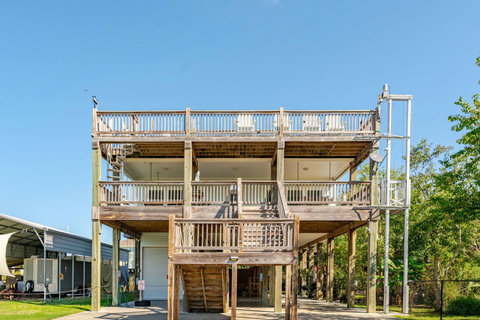 Back of the house with stairs to every deck
