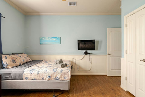 Queen bed with a TV