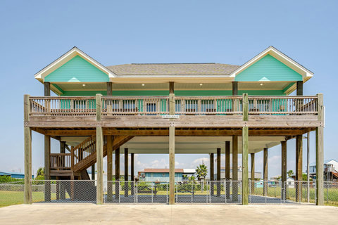 Raised beach house with a long covered deck