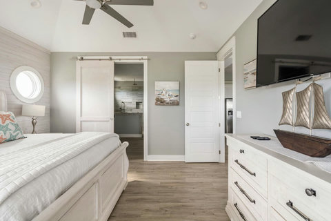 King bedroom with a barn door to the bath