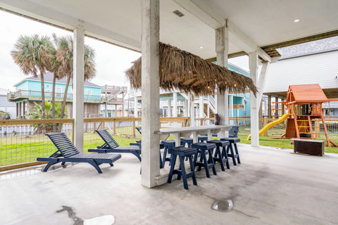 Tiki bar, loungers and a playscape under the house