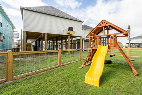 Fenced yard with a playscape