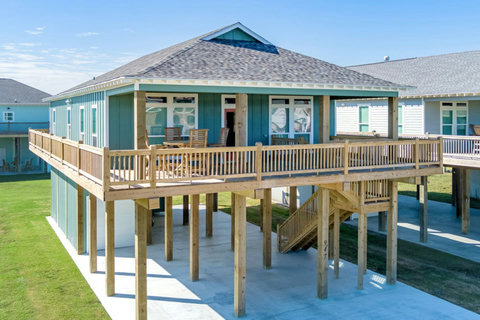 Raised beach house with a wraparound deck