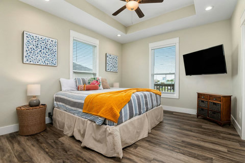 King bedroom with a smart TV and coastal decor