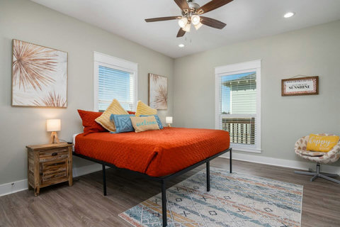 King bedroom with a reading chair