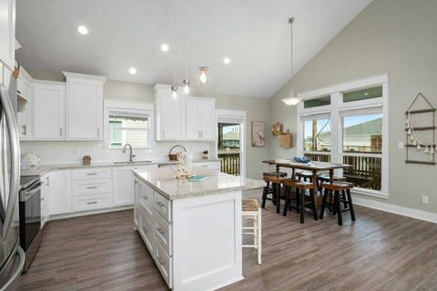 Kitchen with bar stools and dining for six