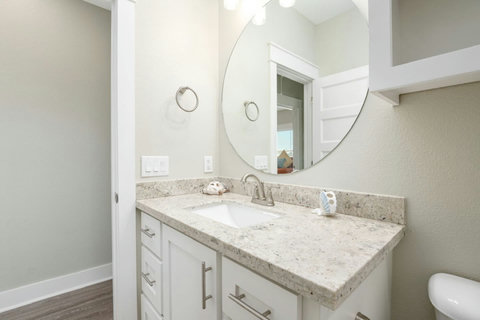Bath vanity with a round mirror