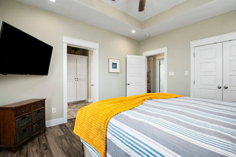 King bedroom with a dresser and closet