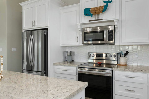 Stainless appliances and a tile backsplash