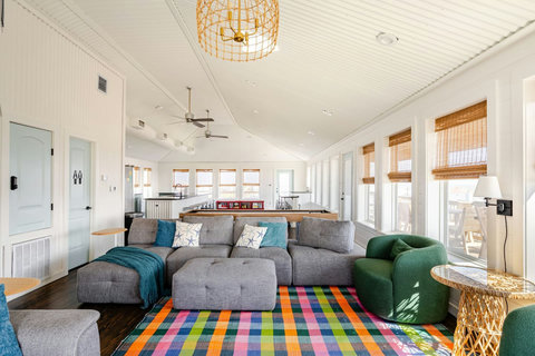 Huge open living room with a sectional and colorful rug