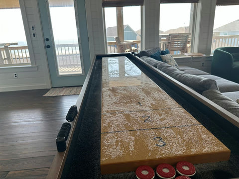 Shuffleboard table by the deck doors