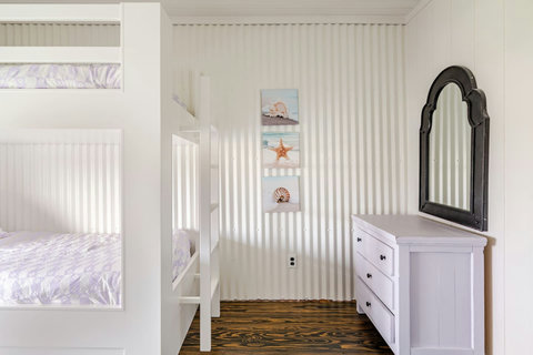 Twin bunk room with a vanity mirror