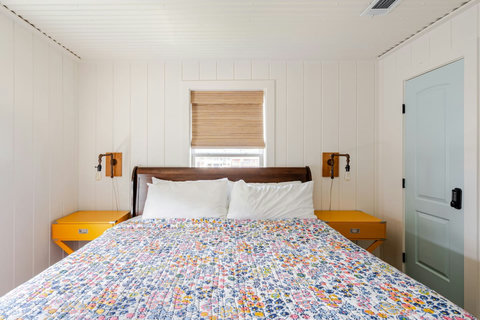King bedroom with bright, cheerful bedding
