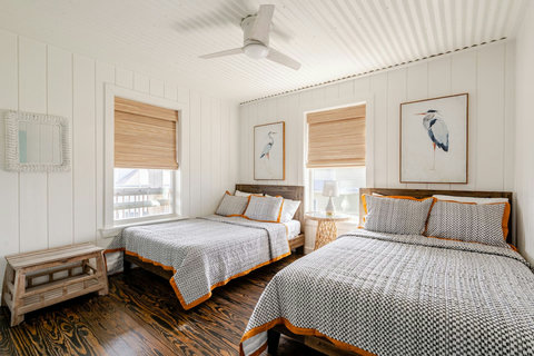 Two full beds with soft gray bedding