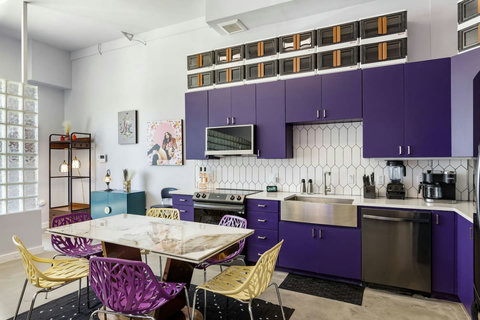 Purple kitchen with a marble-top dining table