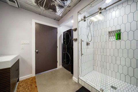 Walk-in shower and stacked washer and dryer